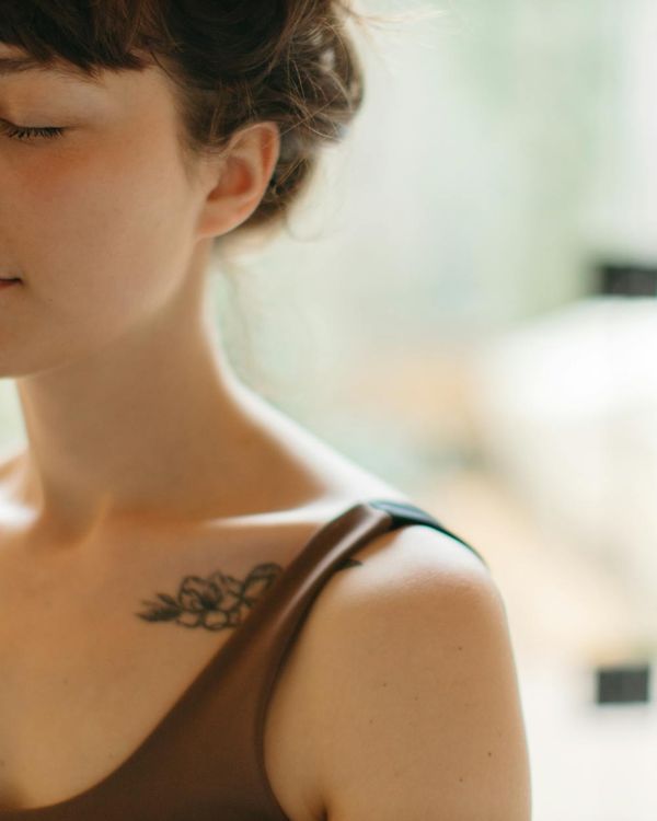 Woman in a peaceful yoga pose in a calm environment.